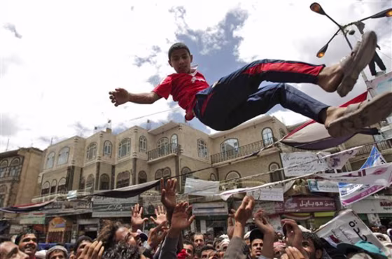 Anti-government protesters reach up to catch a youth after throwing him into the air during a demonstration demanding the resignation of Yemeni President Ali Abdullah Saleh, in Sanaa, Yemen, on May 21.